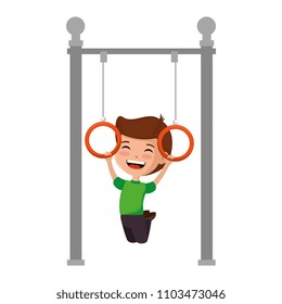 boy playing in park playground rings hanging