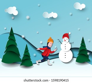 Boy playing with snowman on the winter