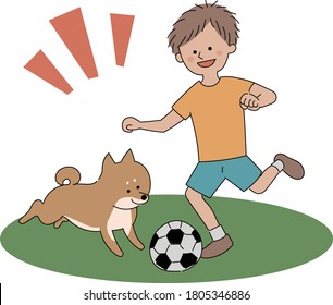 Boy playing soccer with dog