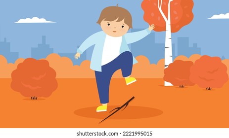 boy playing with a stick in autumn park