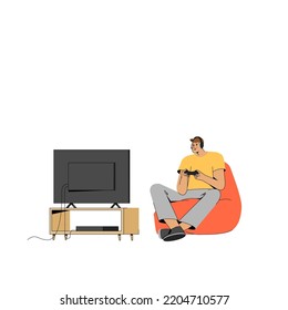 The boy plays a video game with a joystick at home in the console.