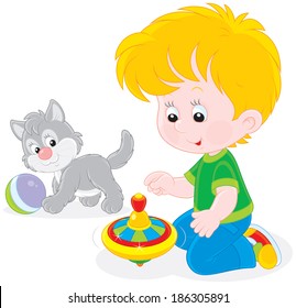 Boy plays with a whirligig and kitten