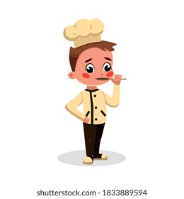 Boy Professional Chef Character Trying Food with Spoon, Cute Kid in Uniform and Hat Cooking Tasty Dish Cartoon Style Vector Illustration