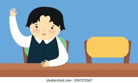 The boy raises his hand while sitting at the desk in the classroom