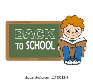 Boy reading a book next to a blackboard with space for text