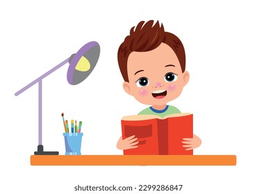 A boy is reading a book on a desk.