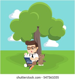 boy reading book under tree