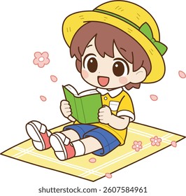 A boy reading a book while having a picnic