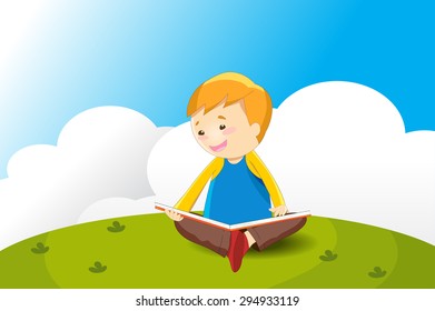 Boy reading on the green field 
