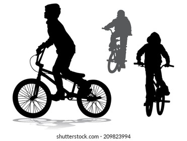 A boy rides a bicycle.