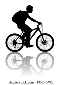 A boy rides a bicycle with a backpack.