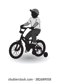 A boy rides a bicycle on a walk.