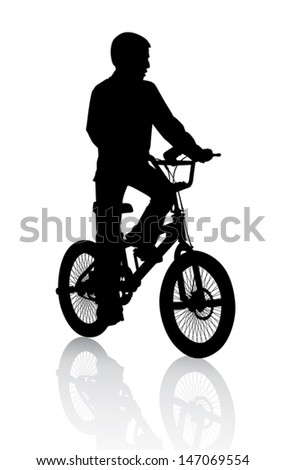 A boy rides a bicycle on a walk. 