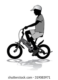 A boy rides a bicycle on a walkway