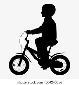 A boy rides a bicycle silhouette