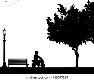 Boy rides on a motorcycle toy in park, one in the series of similar images silhouette
