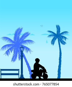 Boy rides on a motorcycle toy on the beach, one in the series of similar images silhouette