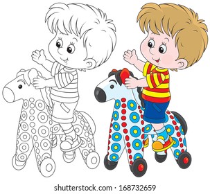 Boy riding on a colorful toy horse