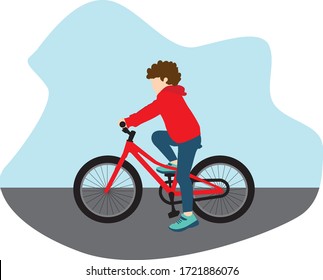 Boy riding a red bike on the street wearing a red hoodie.