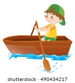 Boy rowing in a wooden boat