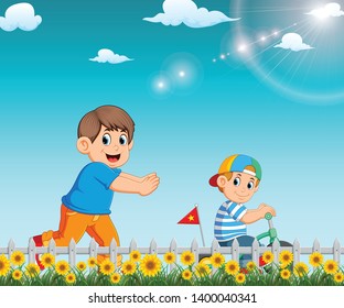 the boy is running to his brother who riding the bicycle in the garden