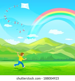Boy running with a kite on a green meadow