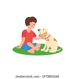 A boy sits on a carpet with a dog. Man's best friend. Happy pet owners.