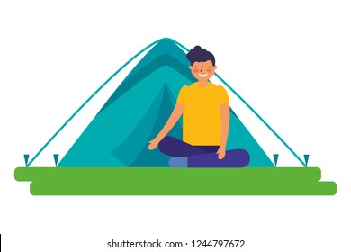 boy sitting crossed legs with tent camping