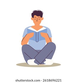 A boy is sitting and reading a book