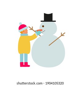 boy in the snow making a snowman