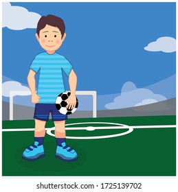 Boy soccer player with a ball in his hands on the football ground.