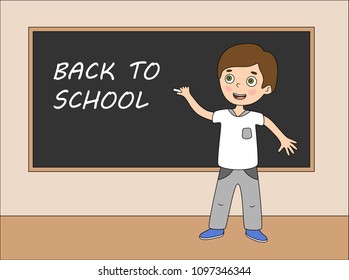 Boy standing in front of school blackboard. Welcome Back to school. The first day at school. Text on chalkboard. Education concept.
