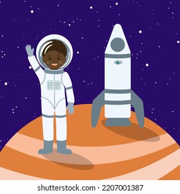 An Αfrican boy stands on the orange planet with a rocket and greets us.