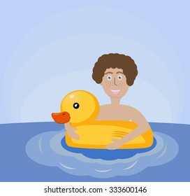The boy swims with inflatable circle duck