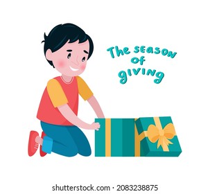 The boy takes out his present from an open gift box. Vector illustration in a flat style. Lettering The season of giving