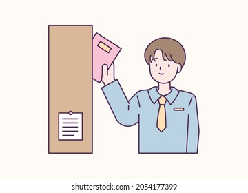 A boy is taking a book out of the bookshelf. flat design style vector illustration.