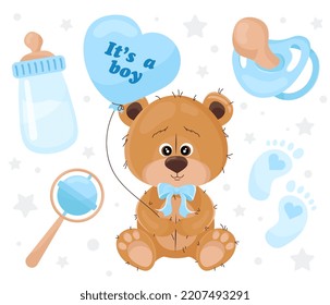 Es un chico. Oso de peluche con un globo en forma de corazón y varios objetos para el bebé.