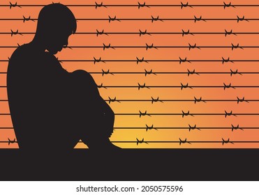
Boy, teenager, young man, man, criminal or gentleman behind a spiked fence at sunset