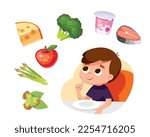 Boy thinking, considering healthy eco food sitting at the table. Child choosing meal for breakfast, lunch. Boy choose what to eat for supper, dinner or snack. Hungry kid have a meal.