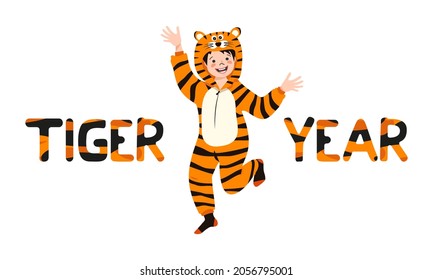Boy in tiger carnival costume and inscription New Year from striped orange with black letters. Children pajama party or holiday. Kid in jumpsuits or kigurumi, festive clothing for Christmas