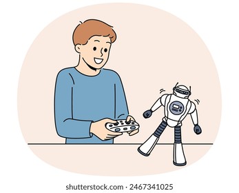 Boy with toy remote controlled robot for concept of learning robotics. Schoolboy is passionate about playing with robot and dreams of becoming engineer or creating cyborgs with artificial intelligence