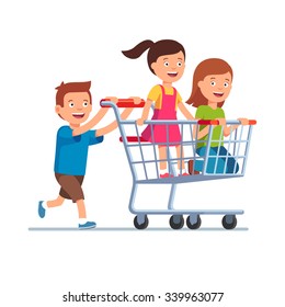 Boy and two girls playing together, riding supermarket shopping cart. Flat style vector illustration isolated on white background.