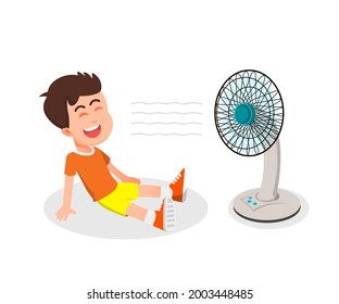 a boy uses a fan to cool his body