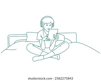 Boy using his digital tablet at bedroom