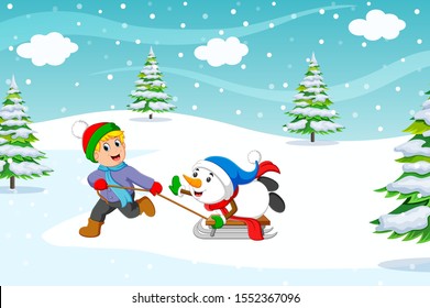 A boy and warm coat playing a sleigh ride with a snow	