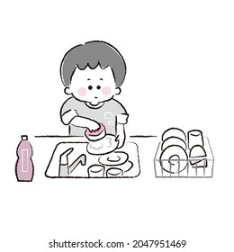 Boy washing dishes in the kitchen.