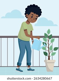 Boy watering potted plant on balcony
