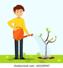 boy watering a tree.the guy is watering the tree from a colorful watering can, a boy caring for plants