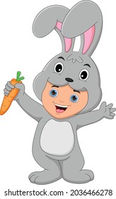 boy wearing rabbit costume holding a carrot