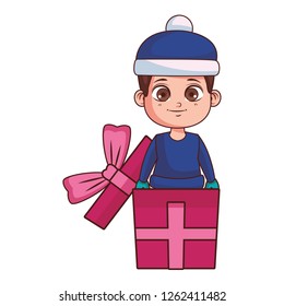 Boy with winter clothes inside gift box